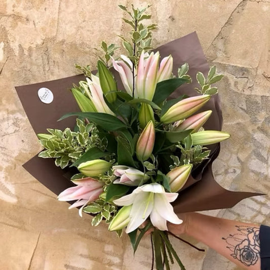 Stunning bouquet of long-stemmed Oriental lilies from WA, elegantly wrapped in brown paper and mesh with a jute tie.