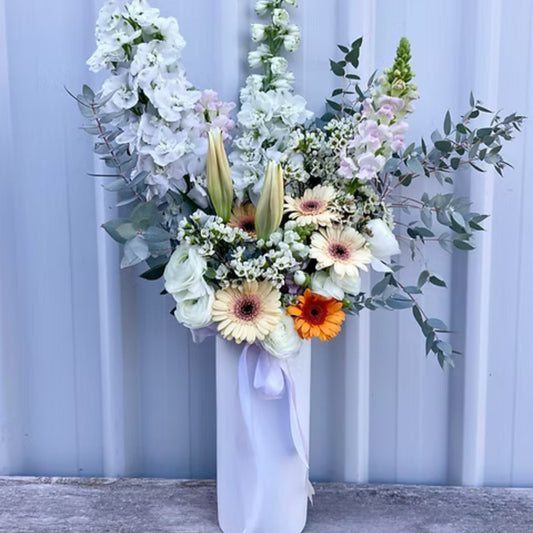 Vibrant Deluxe Seasonal Arrangement featuring fresh lilies, chrysanthemums, and local blooms in a stylish large vase.
